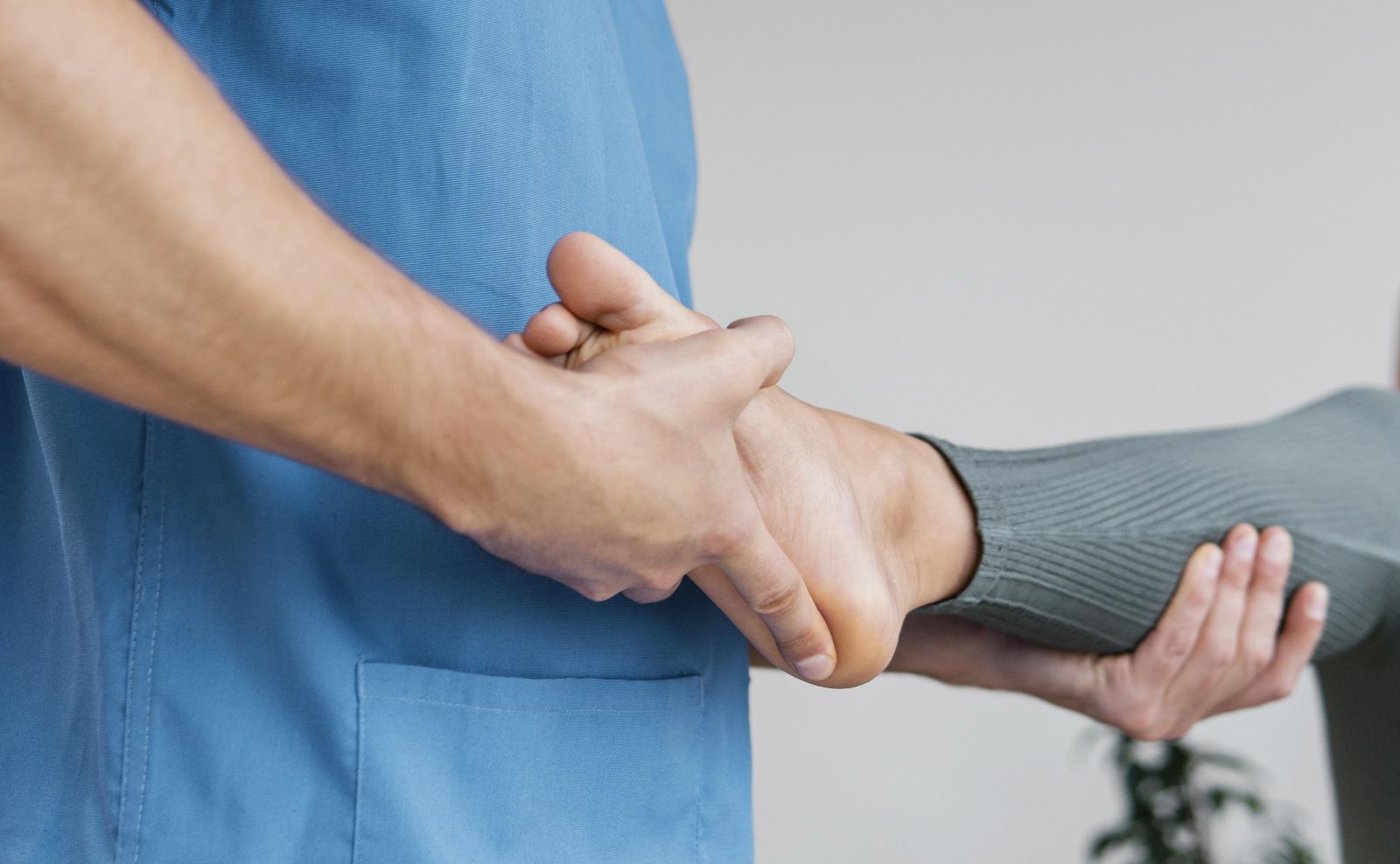 low-angle-male-osteopathic-therapist-checking-female-patient-s-leg-movement.jpg